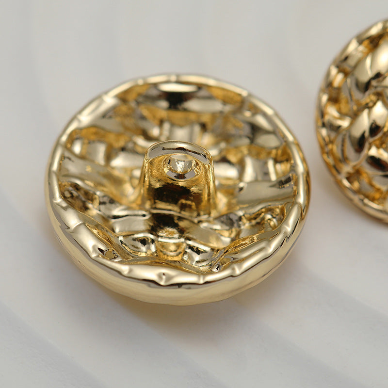 Gold round metal shank button underside with loop for sewing, braided texture