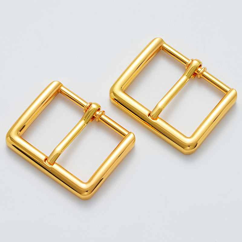 Two gold metal waist buckle pieces with hinged bars and rectangular loops
