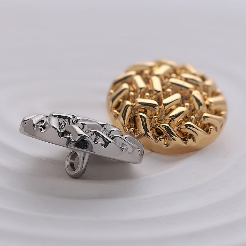 Side view: gold and silver round metal sewing buttons with rice-grain embossing, shank