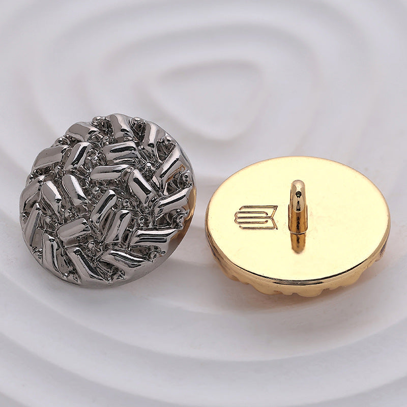 Silver and gold round metal sewing buttons with rice-grain embossing, shank view