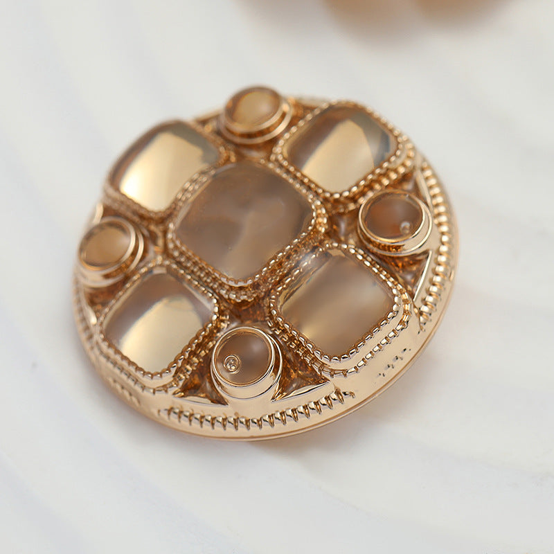 Rose gold metal shank buttons, close-up front with crosshatch square inlays