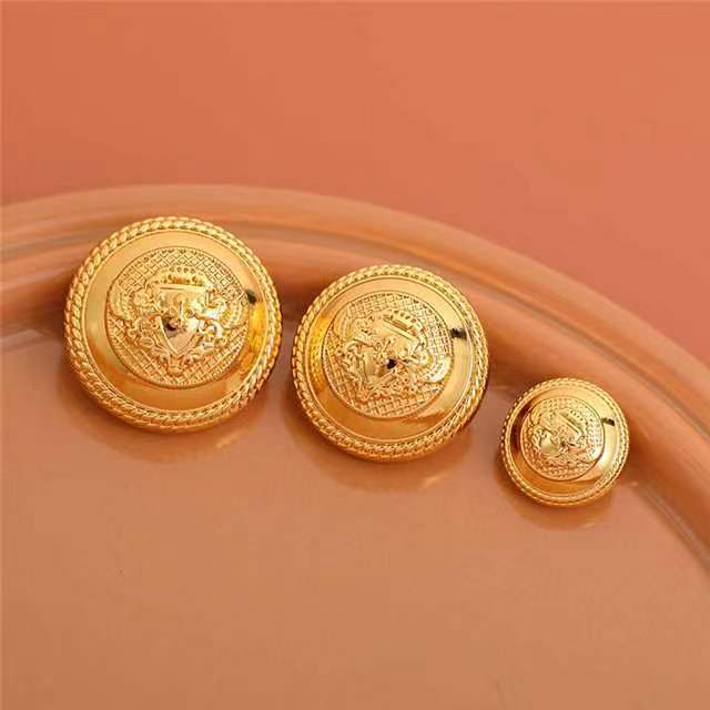 Gold vintage lion metal buttons, multiple pieces with ornate border, arranged