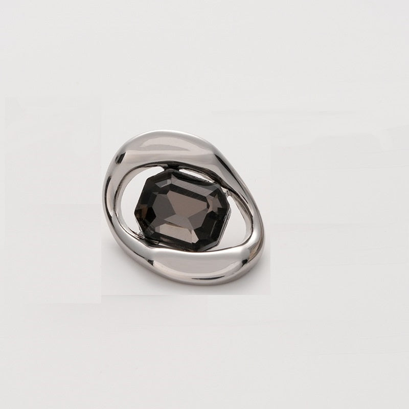 Silver-tone metal button with dark faceted crystal, square irregular geometric setting