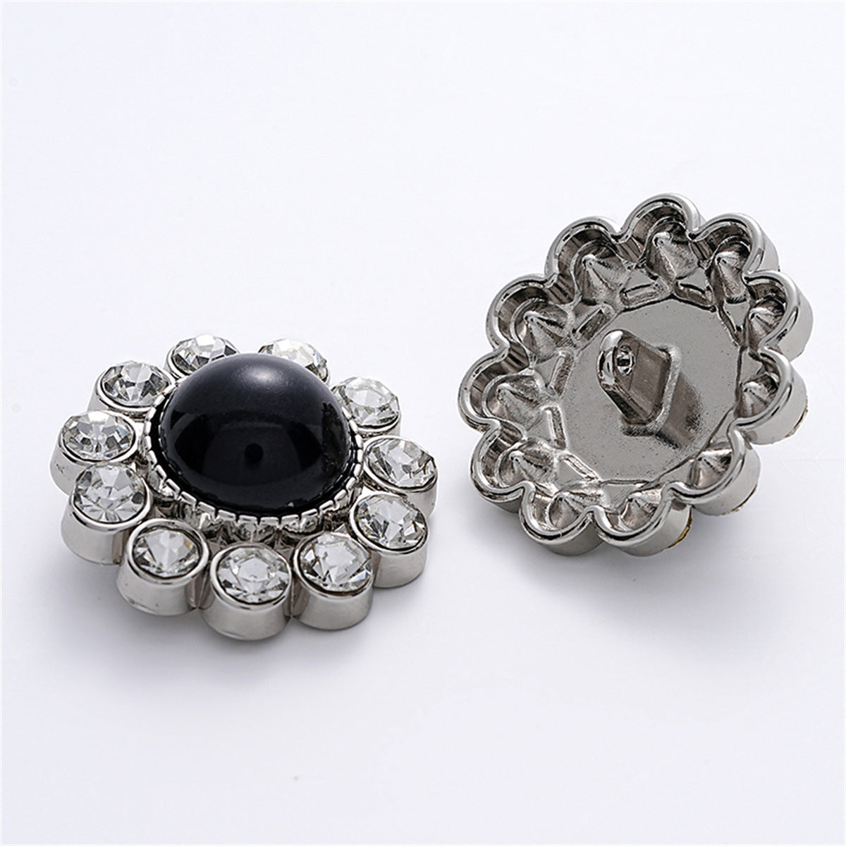 Cat’s eye pearl button front and metal back, rhinestone surround