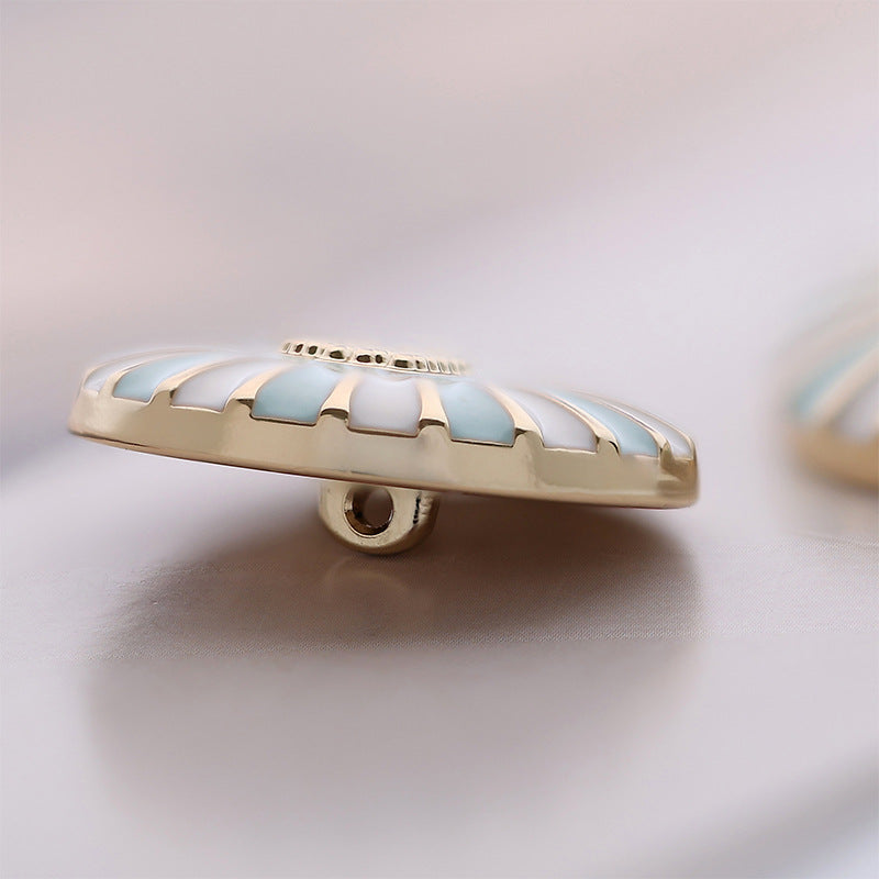 Side view of round button with goldtone base and sky blue/white enamel, sewing shank
