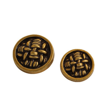 Knot-shaped metal buttons, black face with gold rim, pair