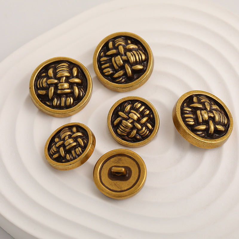 Set of knot-shaped metal buttons, black fronts with gold-toned edging