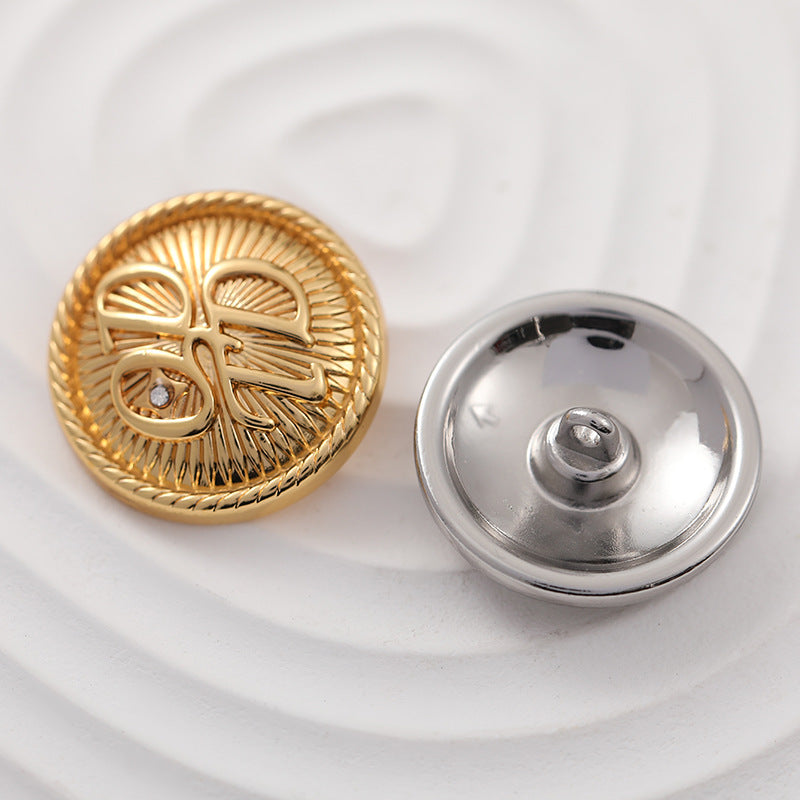 Gold front metal button and silver back with loop shank, ornate etched design
