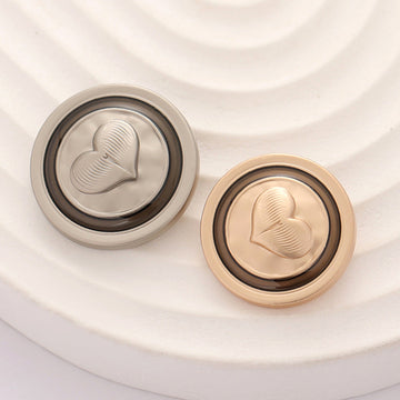 Round metal coat button with embossed heart, silver tone