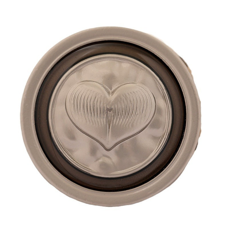 Silver-tone round metal coat button with embossed heart design