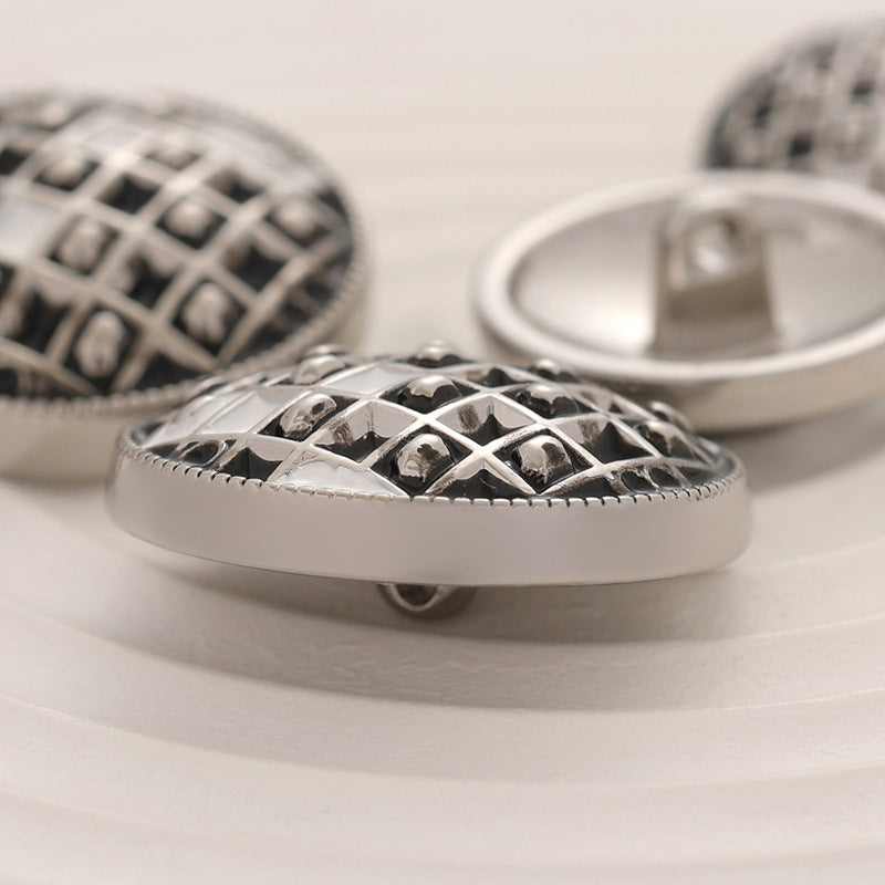 Side view of 18-23mm black & white checkerboard epoxy metal button, shank visible