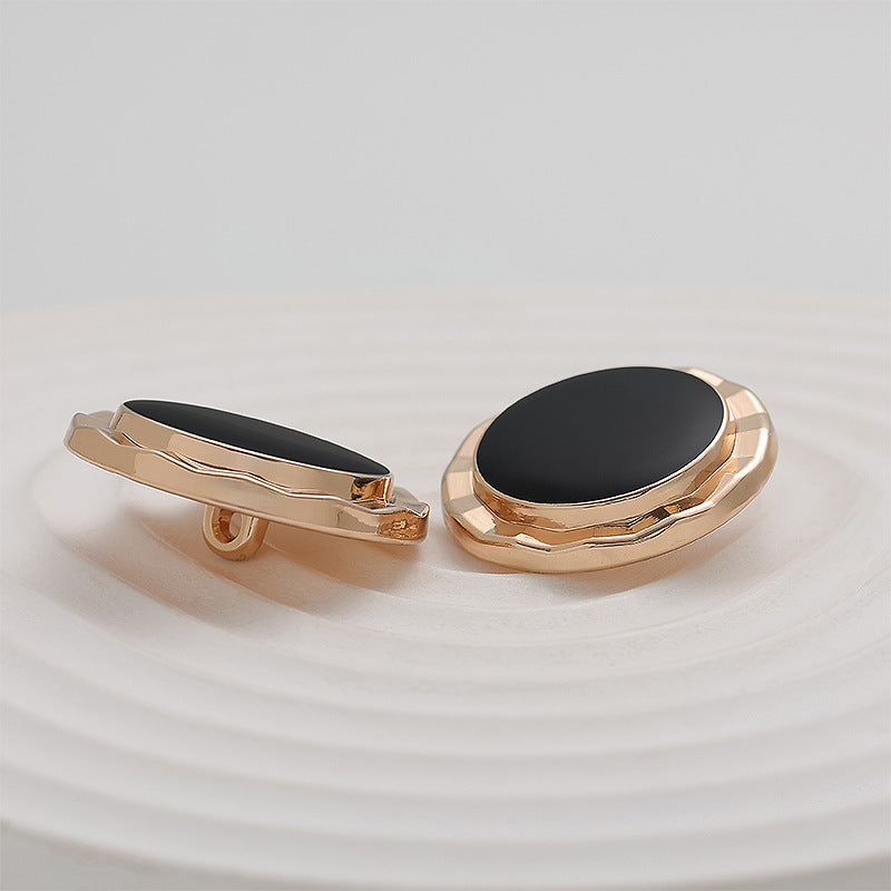 Gold metal button setting with black epoxy face, 23mm, side view