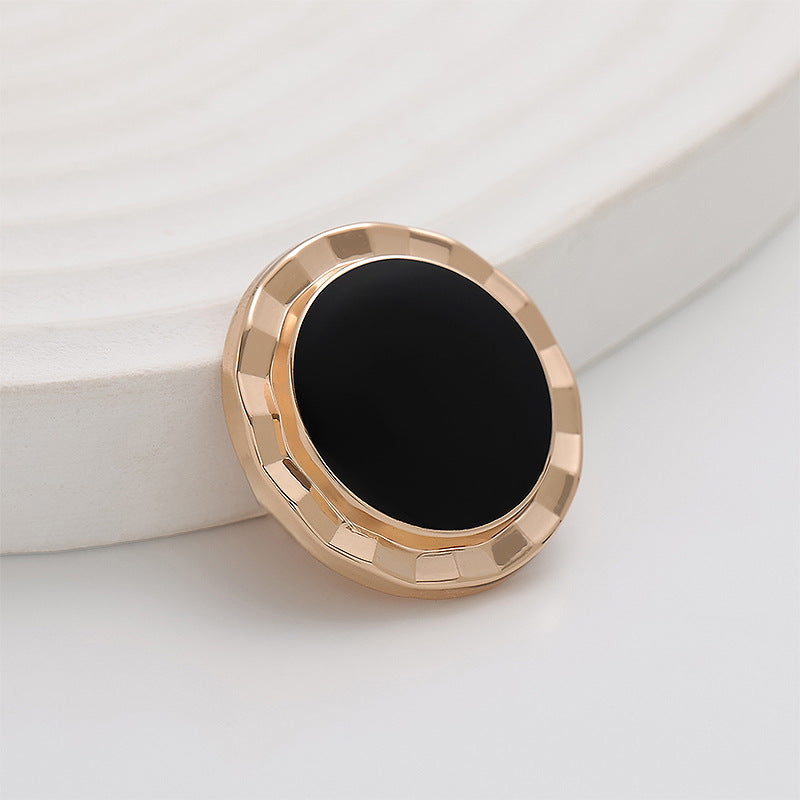 Round black epoxy center with gold scalloped metal frame, 23mm button