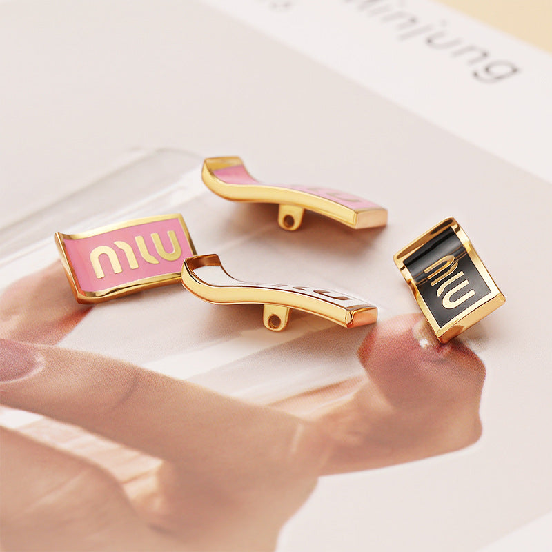 MIU rectangular metal buttons, pink and black fronts, gold-tone sewing loops