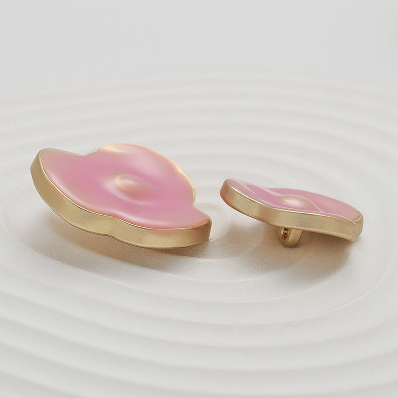 Pink irregular flower metal sewing buttons, side view showing gold loop attachment