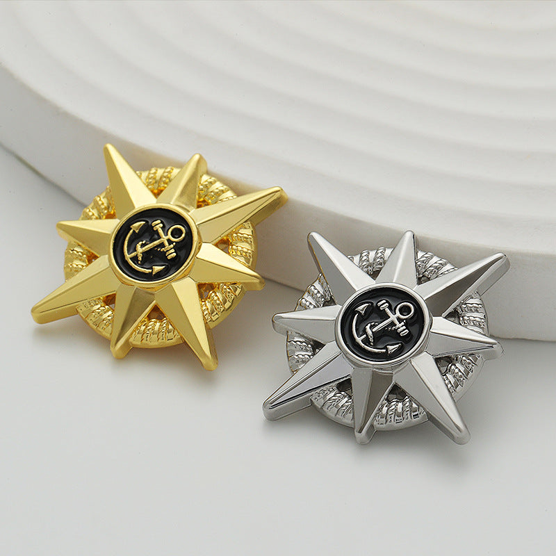 Gold anchor star brooch beside silver anchor star brooch with epoxy round center