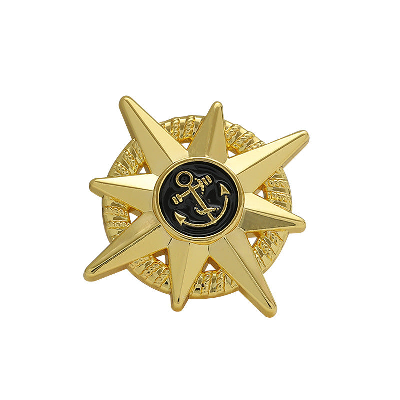 Gold anchor star-shaped metal brooch with black epoxy center and octagonal star edges