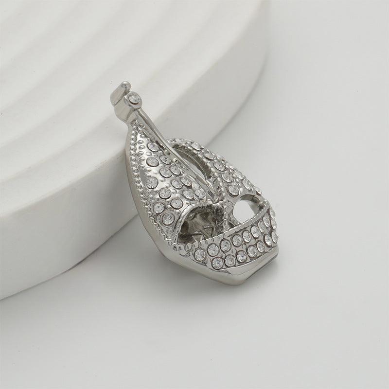 Silver sailboat brooch pin angled view, pavé rhinestones on the hull