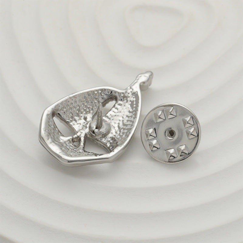 Silver sailboat brooch pin, back view with star-patterned clasp disc