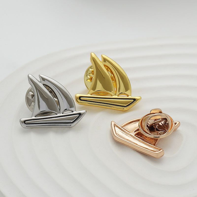 3 boat-shaped brooch pins: silver, gold, and rose gold with pin backing