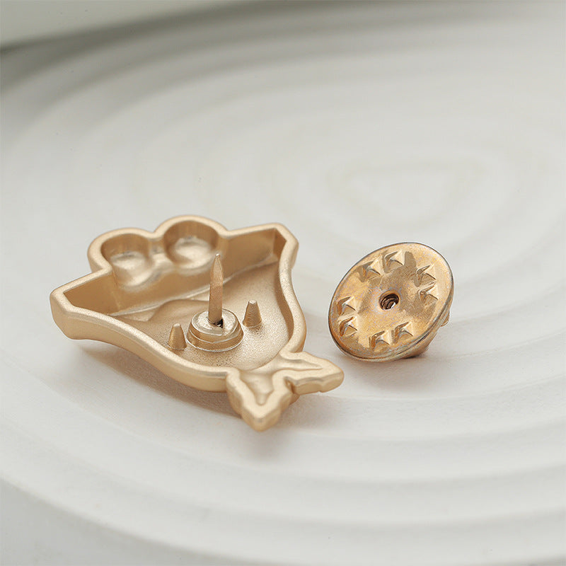 Gold Christmas bell brooch back view with pin and round clasp