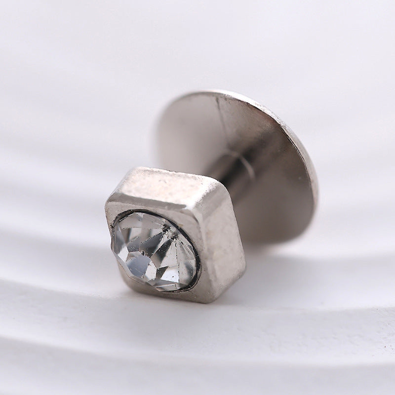 Silver crystal cufflink stud close-up, faceted stone in square bezel