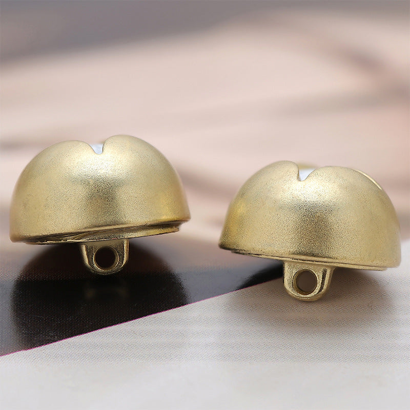 Gold mushroom-shaped metal decorative button underside with two mounting holes