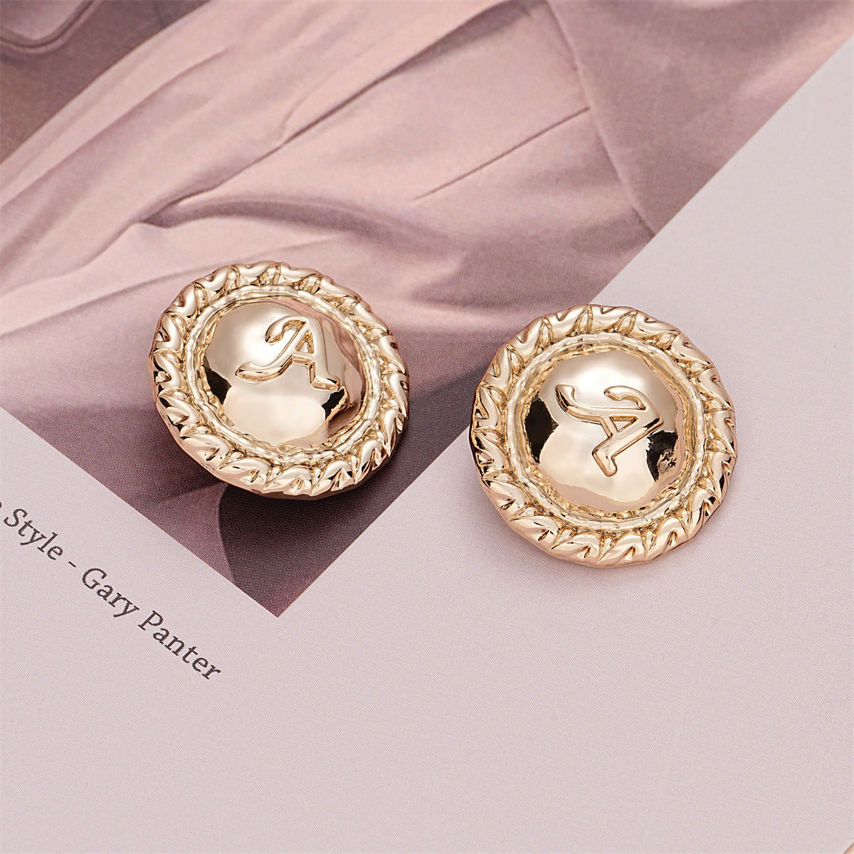 Pair of 23mm light gold round buttons with letter A and braided decorative rim