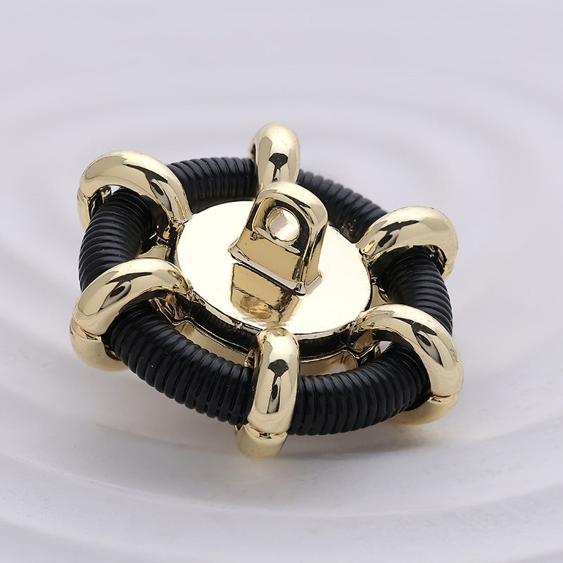 Hollow pearl sewing button close-up: black ribbed edge, gold top shank, pearl dome