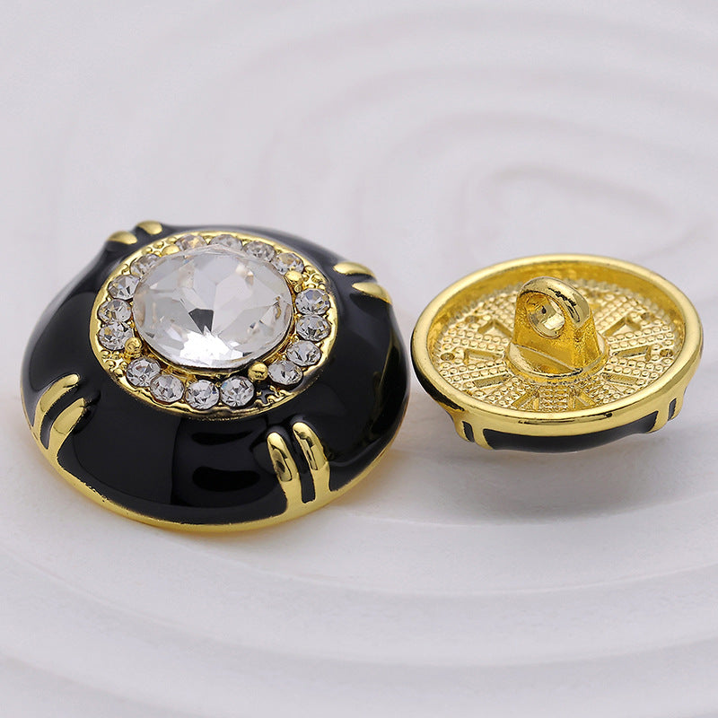 Black sewing button front with clear crystal; gold-tone back with shank