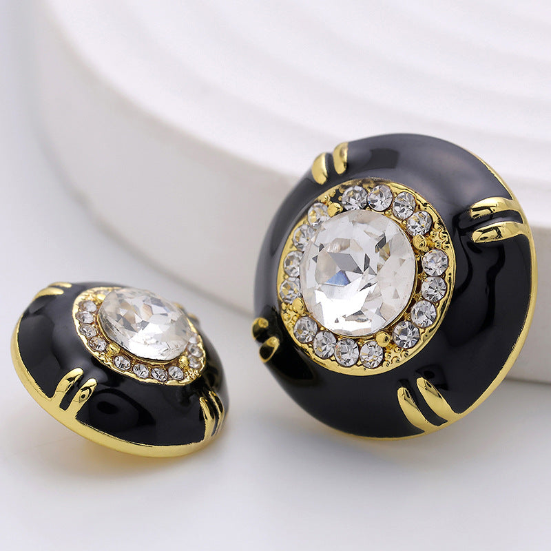 Black sewing buttons (2): clear crystal centers with gold-tone trim