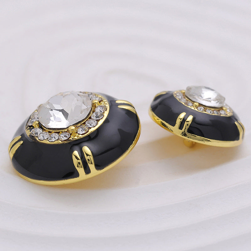 Black epoxy sewing button with clear gem ring and gold accents