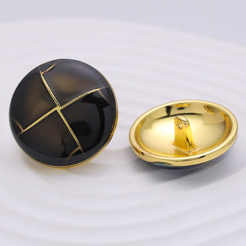 Black crosshatch button showing gold back with shank and gold metal rim