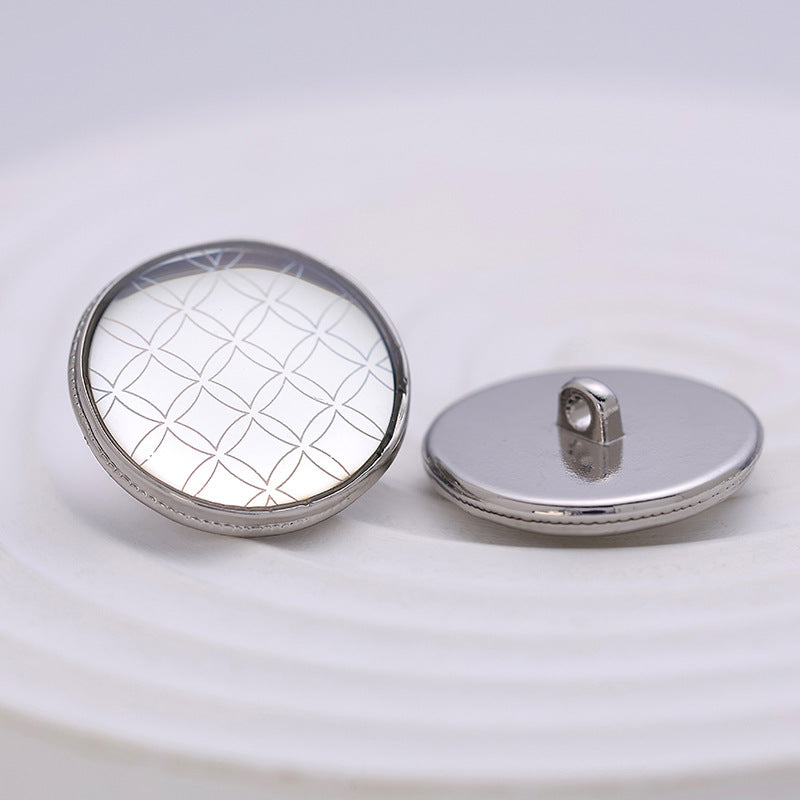 Silver round metal button; front shows rainbow check pattern, back has shank post