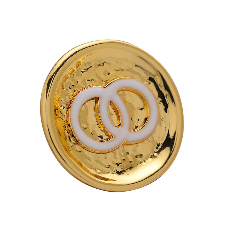 White gold double-circle metal button with white enamel interlocking C detail