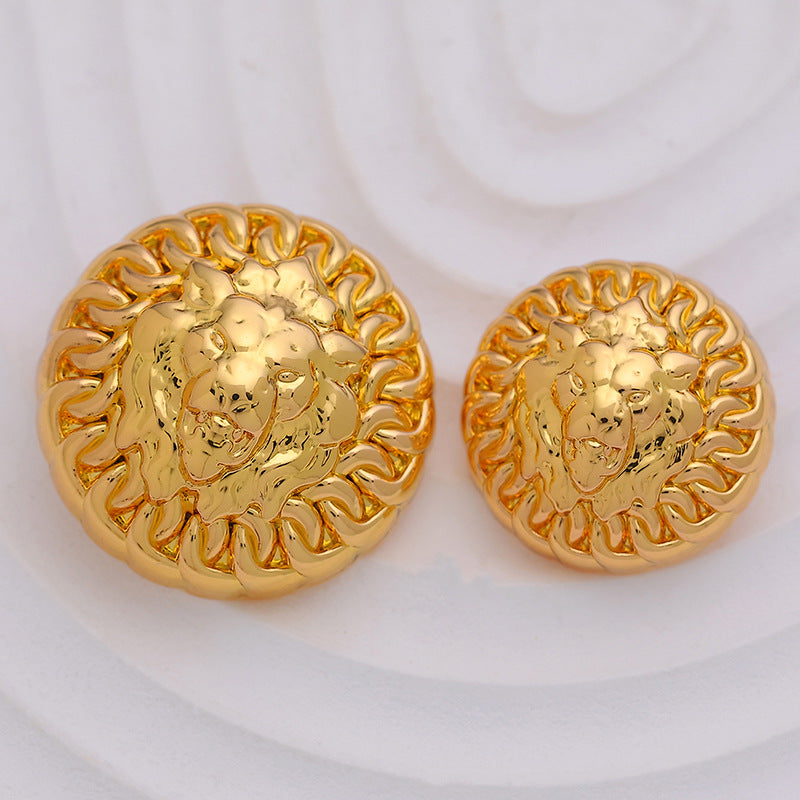 Set of round lion head metal buttons, shiny gold finish, front view