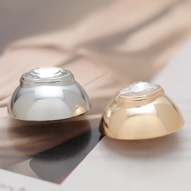 Set of convex buttons: silver and gold finishes with faceted crystal centers