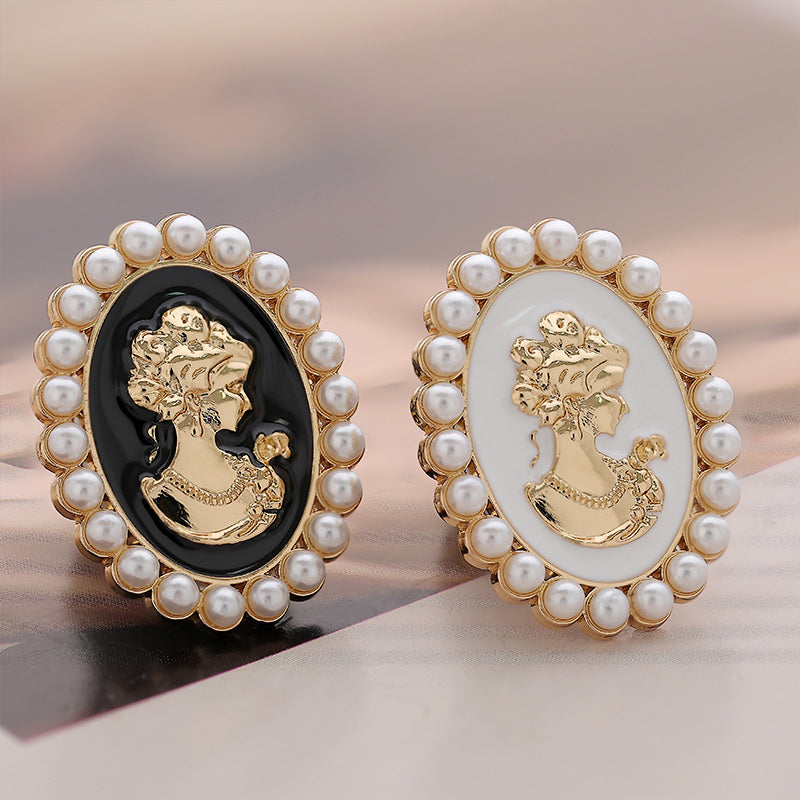 Pearl brooch set: one black and one white oval cameo, gold beauty portrait, gold frame