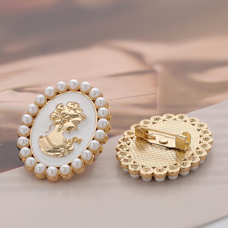 Pearl brooch pin with white cameo front and gold clasp/back details, portrait medallion
