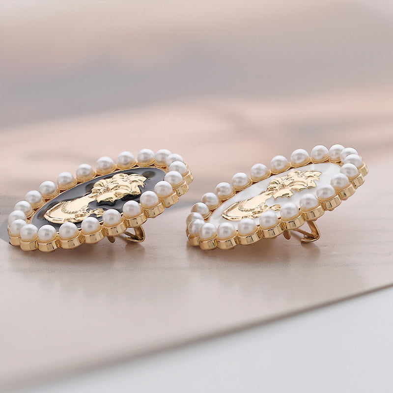 Retro Palace pearl brooch pins, gold back plates and pin stems, black and white ovals