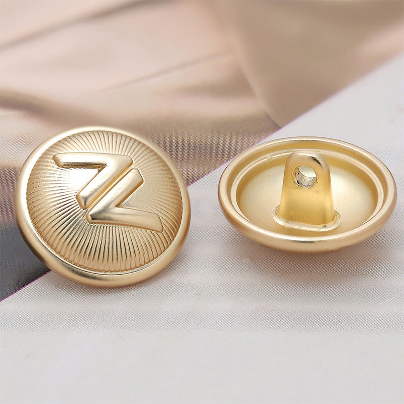 Light gold metal sewing button back and front, center shank opening
