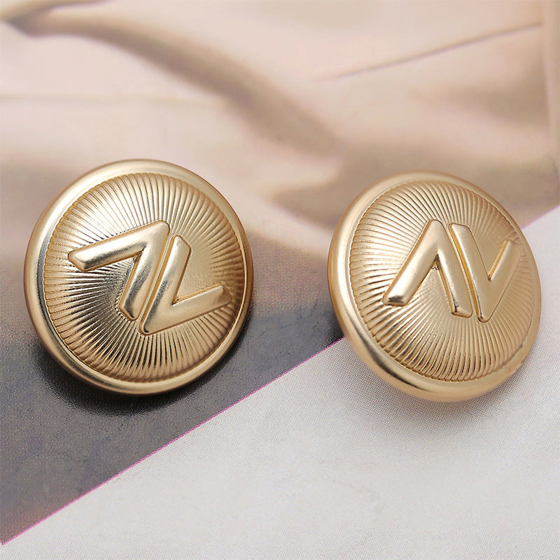 Light gold 18mm metal sewing buttons with raised V design, front view