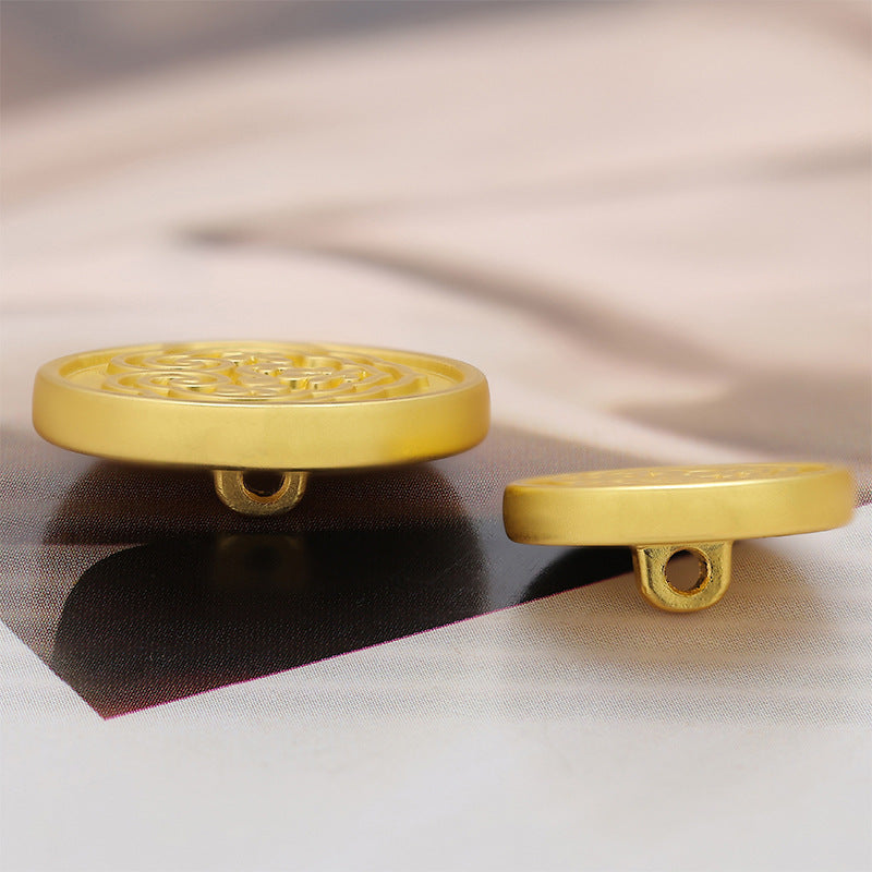 Gold-tone metal button with loop shank, patterned face view