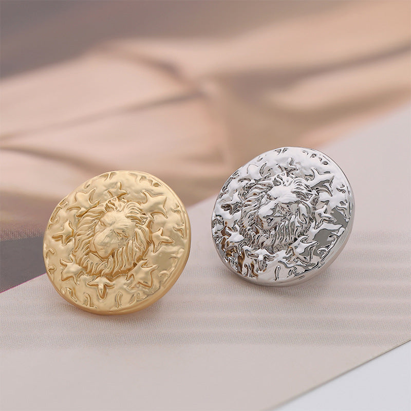Pair of round metal buttons: gold and silver lion head designs