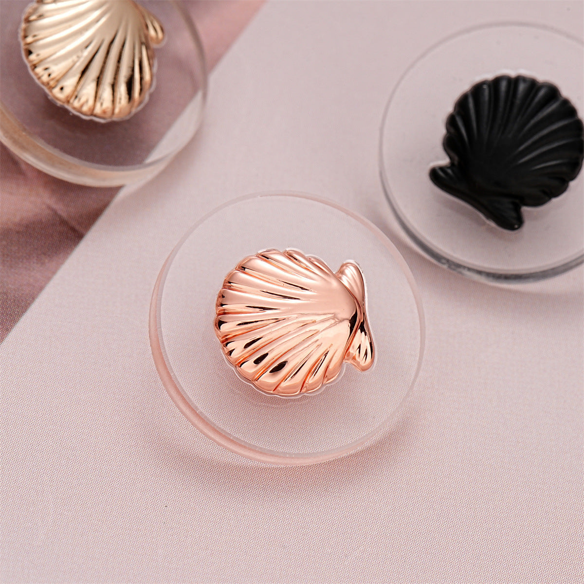 Pink shell button with rose-gold ridges, acrylic front and metal shank
