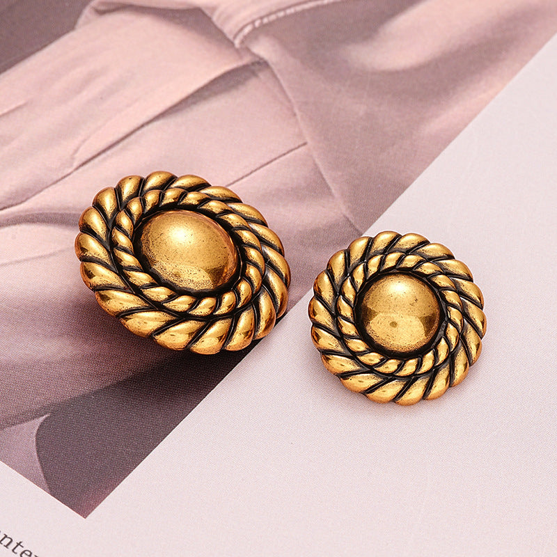 Two antique gold round metal buttons with braided rim and central shank