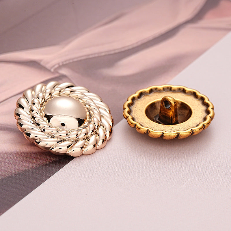 Silver front and antique gold back view of braided round metal button with shank