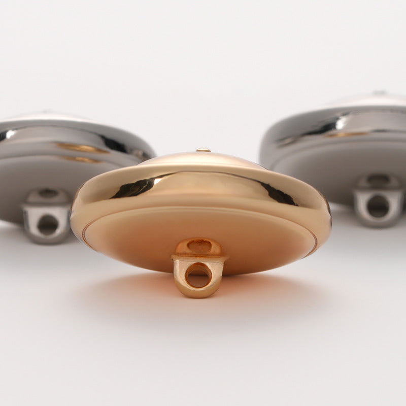 Light gold metal button, round face with hollow back and 2-hole shank stem