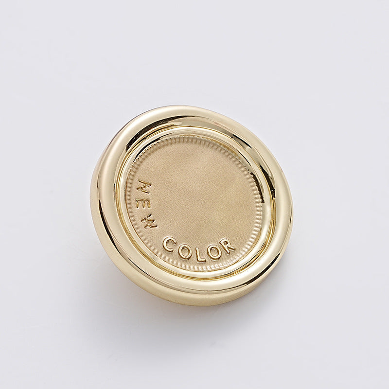 Khaki-gold two-tone round metal sewing button, handle loop, fabric top face.