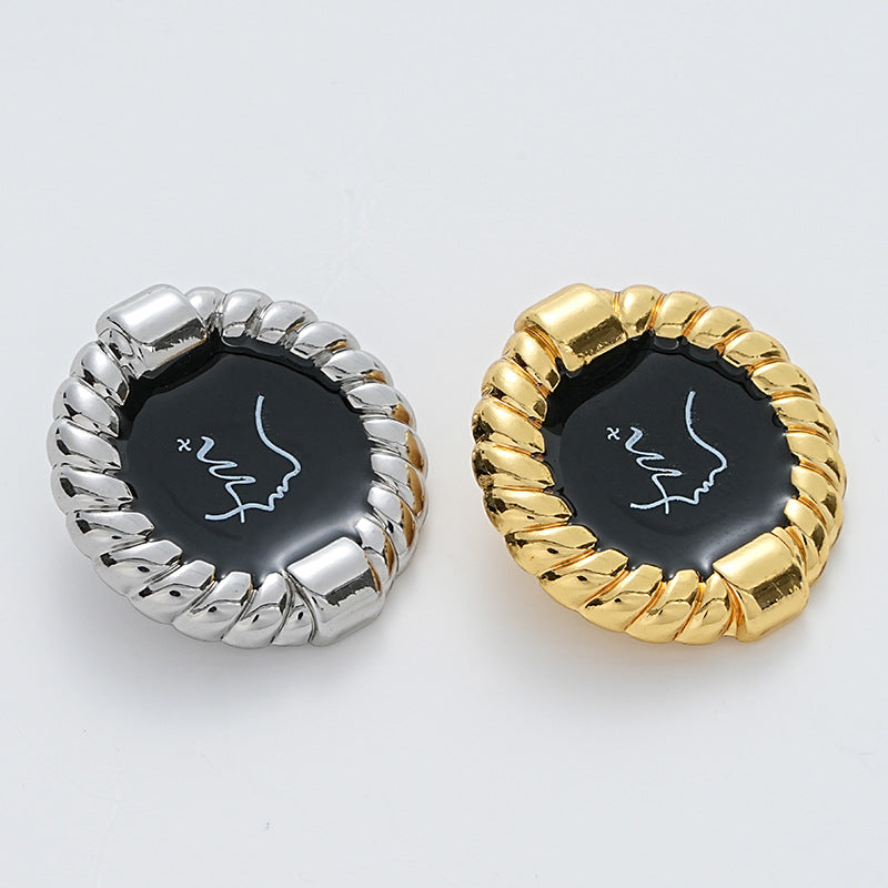 Silver and gold metal buttons with black glossy faces and rope-edge borders